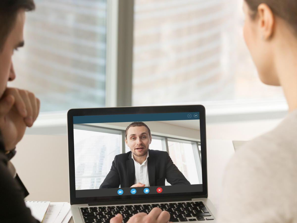 Man video conferencing with clients